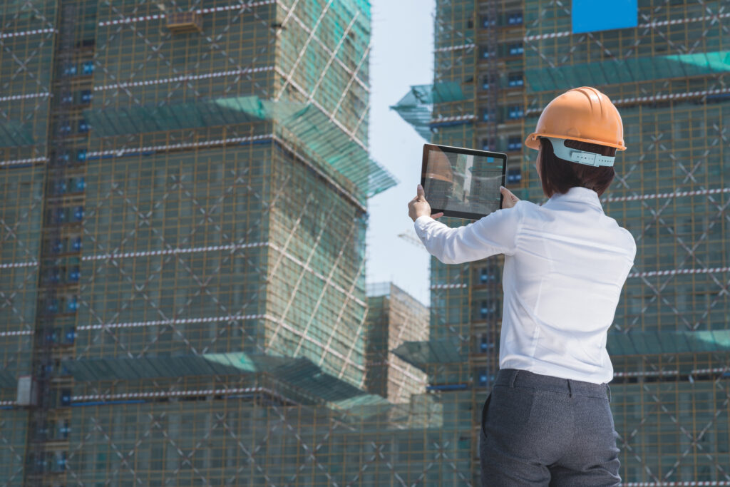 Inspector photographing a building project under construction